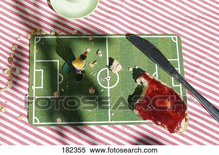 Close-up of jam on slice of bread and figurine of soccer player View Large Photo Image Stock Photography - Close-up of jam on slice of bread and figurine of soccer player . Fotosearch