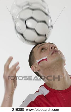 Close-up of man balancing soccer ball on his head View Large Photo Image Stock Image - Close-up of man balancing soccer ball on his head . Fotosearch