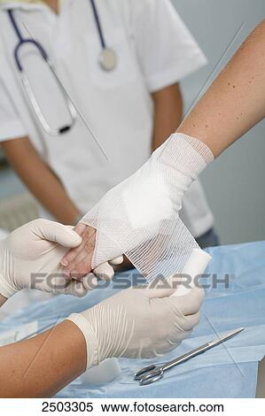 Close-up of nurse's hands wrapping patient's wrist View Large Photo Image Stock Photography - Close-up of nurse's hands wrapping patient's wrist . Fotosearch