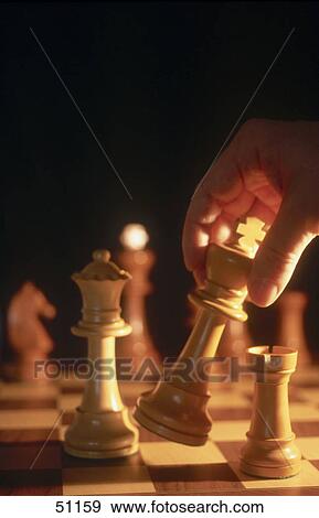 Stock Photo - Close-up of person playing chess . Fotosearch