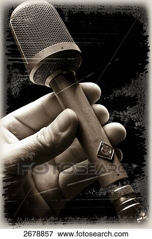 Close-up of person's hand holding microphone View Large Photo Image Stock Photo - Close-up of person's hand holding microphone . Fotosearch