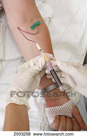 Stock Photo - Close-up of person's hands taking blood sample from patient's arm . Fotosearch