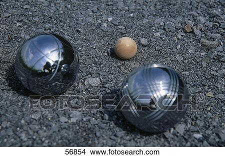 Picture - Close-up of Petanque balls on soil . Fotosearch