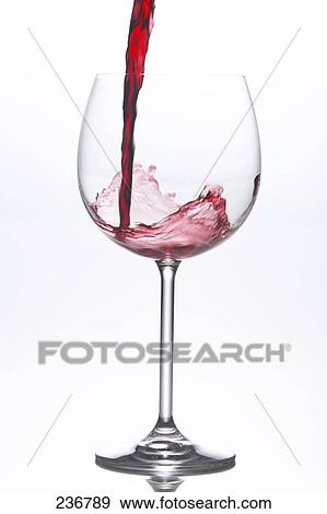 Close-up of red wine being poured into wine glass View Large Photo Image Stock Photo - Close-up of red wine being poured into wine glass . Fotosearch