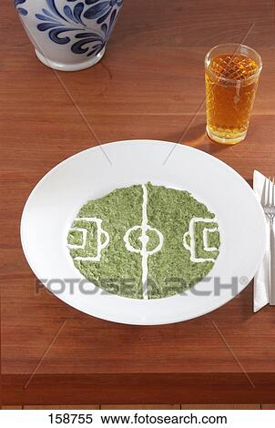 Stock Photography - Close-up of sauce of spinach on plate and glass of apple juice . Fotosearch