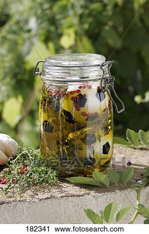 Stock Image - Close-up of soccer balls in airtight jar . Fotosearch