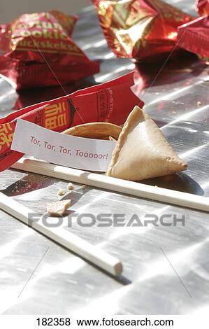 Close-up of tor fortune sticking out of fortune cookie View Large Photo Image Stock Photo - Close-up of tor fortune sticking out of fortune cookie . Fotosearch