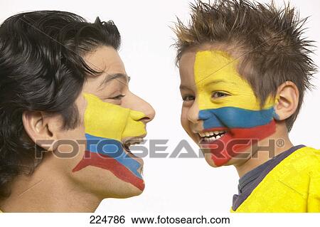 Stock Photograph - Close-up of two soccer fans with Ecuador painted flag on their faces . Fotosearch