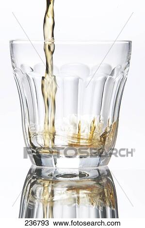 Stock Image - Close-up of whiskey being poured into glass . Fotosearch