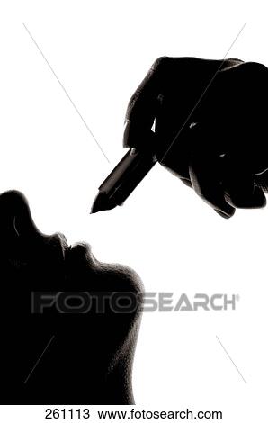 Close-up of woman applying lipstick View Large Photo Image Stock Image - Close-up of woman applying lipstick . Fotosearch