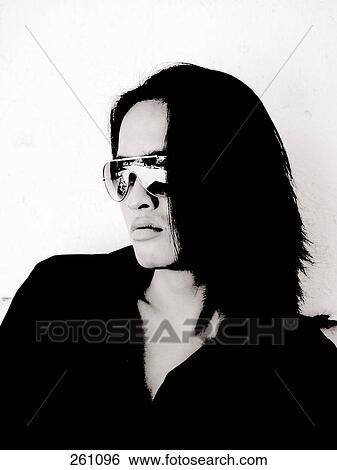Stock Photograph - Close-up of young man wearing sunglasses . Fotosearch