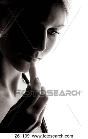 Close-up of young woman applying lipstick View Large Photo Image Stock Photo - Close-up of young woman applying lipstick . Fotosearch