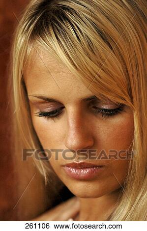 Close-up of young woman looking sad View Large Photo Image Stock Photograph - Close-up of young woman looking sad . Fotosearch