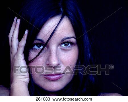 Stock Image - Close-up of young woman looking serious . Fotosearch