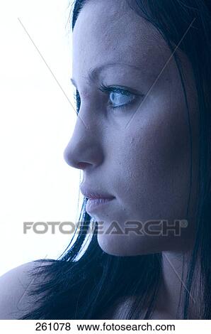 Close-up of young woman looking serious View Large Photo Image Stock Photo - Close-up of young woman looking serious . Fotosearch
