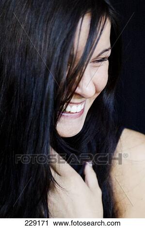 Close-up of young woman smiling View Large Photo Image Stock Image - Close-up of young woman smiling . Fotosearch