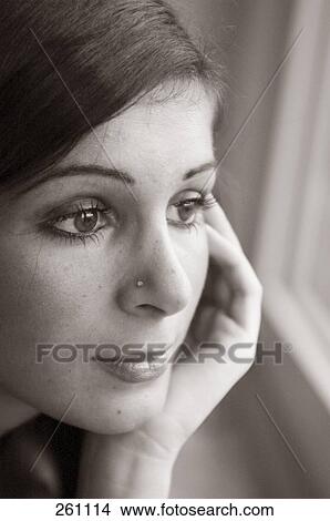 Close-up of young woman thinking  View Large Photo Image Picture - Close-up of young woman thinking . Fotosearch