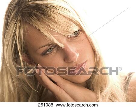 Close-up of young woman thinking View Large Photo Image Stock Photo - Close-up of young woman thinking . Fotosearch
