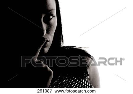 Close-up of young woman with her finger on her lips View Large Photo Image Stock Photo - Close-up of young woman with her finger on her lips . Fotosearch