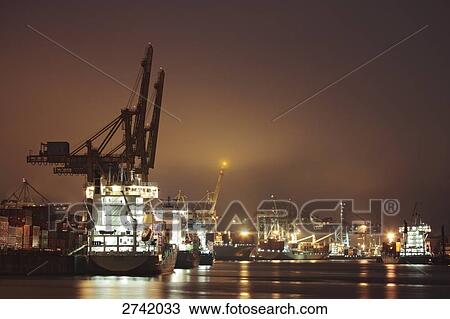 Cranes lit up at night, Hamburg, Germany View Large Photo Image Stock Image - Cranes lit up at night, Hamburg, Germany . Fotosearch