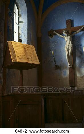 Stock Image - Crucifix and Bible in old church, Oppede, Vaucluse, Provence-Alpes-Cote d'Azur, France . Fotosearch