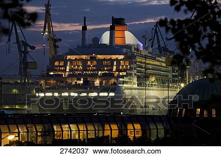 Cruise ship at lit up port during dusk, Hamburg, Germany View Large Photo Image Stock Photo - Cruise ship at lit up port during dusk, Hamburg, Germany . Fotosearch