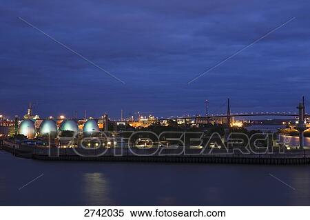 Stock Photography - Digestion towers lit up at night, Koehlbrand Bridge, Hamburg, Germany . Fotosearch