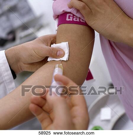 Doctor administering injection into arm of patient View Large Photo Image Stock Photography - Doctor administering injection into arm of patient . Fotosearch