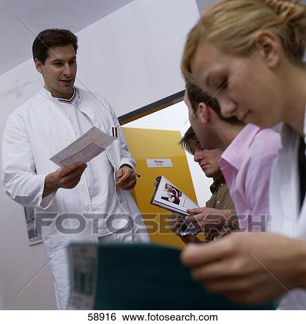 Doctor giving a medical report to a patient View Large Photo Image Stock Photograph - Doctor giving a medical report to a patient . Fotosearch