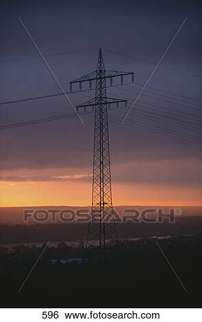Stock Photograph - Electricity pylon at sunset, Germany, Europe . Fotosearch