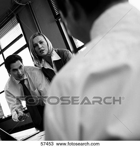 Stock Image - Employees discussing . Fotosearch