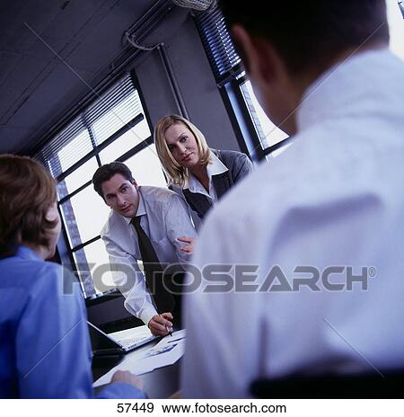 Stock Photo - Employees having a meeting . Fotosearch