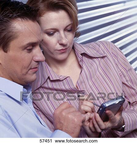 Stock Image - Employees using handheld . Fotosearch