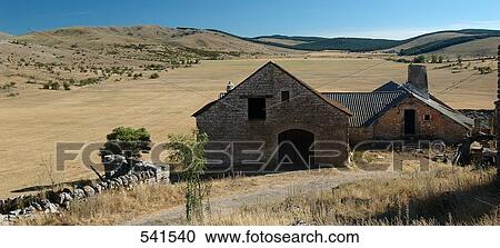 Stock Image - Farmhouses on landscape, Causse Mejean, Auvergne, France . Fotosearch