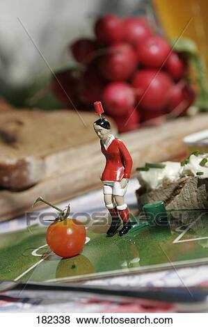 Figurine of soccer player and tomato View Large Photo Image Stock Photo - Figurine of soccer player and tomato . Fotosearch