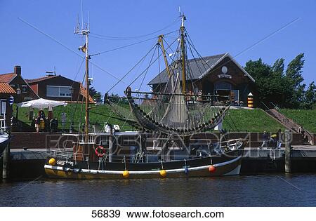 Stock Photo - Fishing boat moored at a pier . Fotosearch