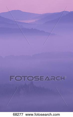 Fog over mountains at dusk View Large Photo Image Stock Photo - Fog over mountains at dusk . Fotosearch