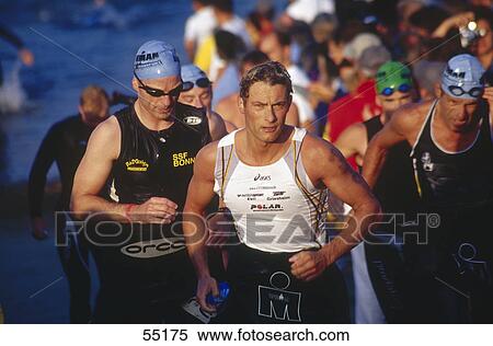 Group of men running in a triathlon event View Large Photo Image Stock Photography - Group of men running in a triathlon event . Fotosearch