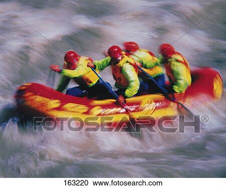 Stock Image - Group of people doing white-water rafting, blurred . Fotosearch