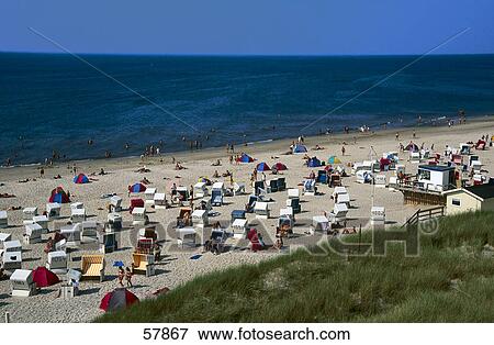 Stock Photo - High angle view of tourists on the beach . Fotosearch