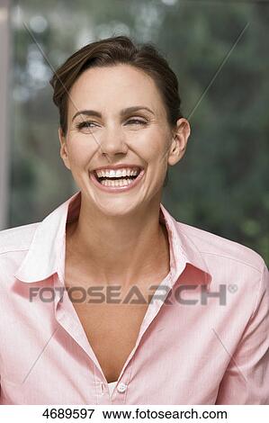 Stock Photo - Laughing woman wearing pink blouse . Fotosearch