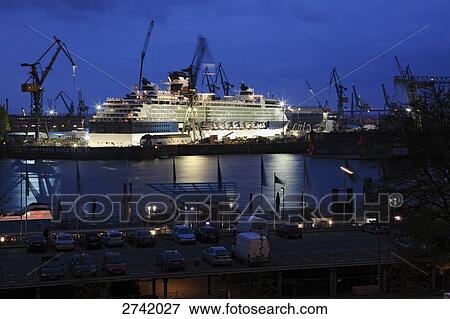 Stock Photo - Lit up shipbuilding yard at dusk, Hamburg, Germany . Fotosearch