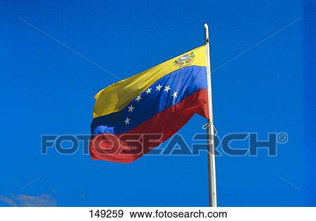 Stock Photo - Low angle view of Venezuelan flag against clear blue sky, Venezuela . Fotosearch