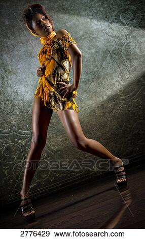 Stock Photo - Low angle view of young woman posing . Fotosearch