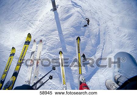 Low section view of skiers sitting on ski lift View Large Photo Image Stock Photography - Low section view of skiers sitting on ski lift . Fotosearch