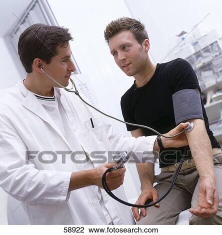 Stock Image - Male doctor checking man's blood pressure . Fotosearch