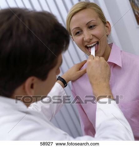 Stock Photo - Male doctor examining patient . Fotosearch