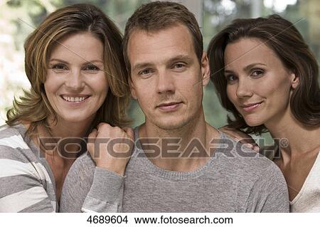 Man between two smiling women View Large Photo Image Picture - Man between two smiling women . Fotosearch
