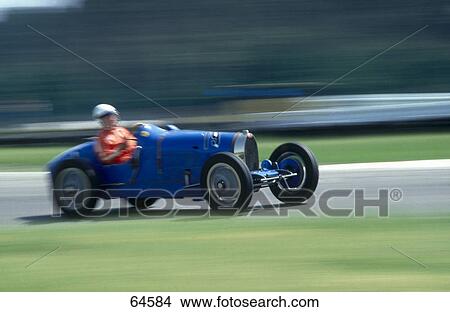 Picture - Man riding race car . Fotosearch
