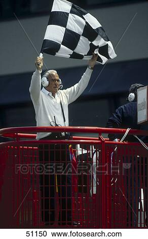 Stock Image - Man waving checkered flag in car racing . Fotosearch